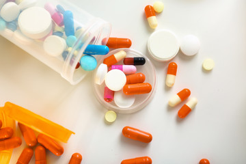 Plastic containers with pills on table