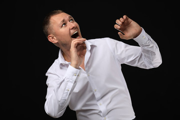 Man having panic attack on dark background