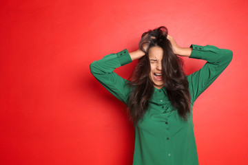 Screaming young woman on color background