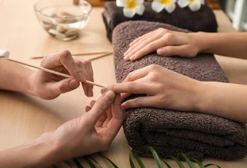 Gardinen Young woman getting manicure in beauty salon © Pixel-Shot