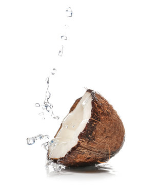 Half Of Fresh Coconut With Water Splash On White Background