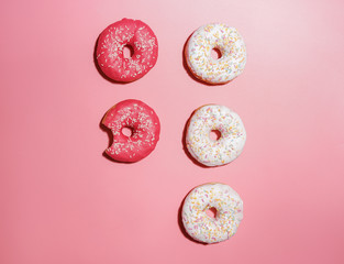 Tasty sweet donuts on color background