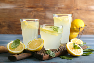 Glasses of fresh lemonade on wooden table