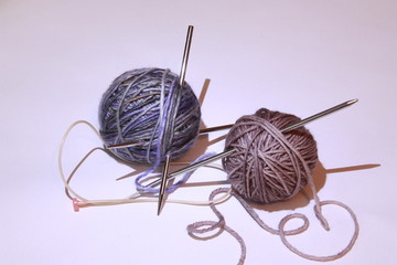 composition with balls of yarn and knitting.