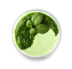 Glass of tasty mint milkshake on white background