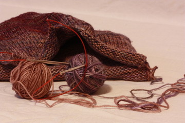 a fragment of knitting with balls of yarn and knitting.