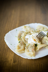 Dumplings boiled with stuffing on a wooden table
