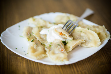 Dumplings boiled with stuffing on a wooden table