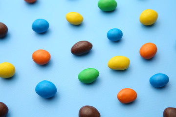 Many colorful candies on color background