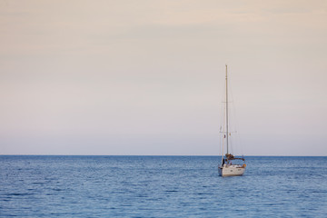 Yacht sail boat on calm sea water
