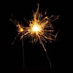 Christmas sparkler isolated on black background. Bengal fire