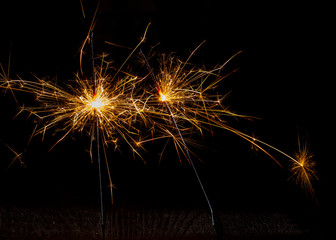 Christmas sparkler isolated on black background. Bengal fire