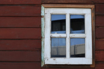 Fototapeta na wymiar Old white window, red wood wall. 