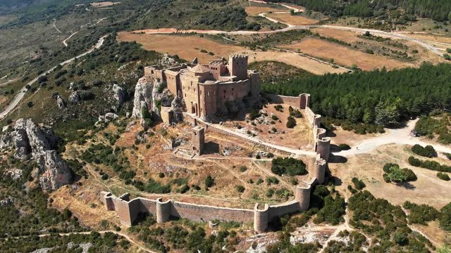 Flying around the Loarre Castle in Aragon, Spain during bright sunny day. It's one of the oldest castles in the country. It was built in 11th century in the Romanesque style. Aerial shot, 4K