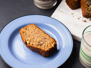 Banana bread loaf sliced on wooden board