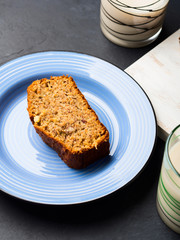 Banana bread loaf sliced on wooden board