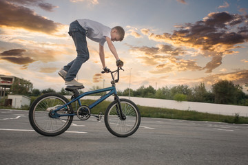 Young boy doing dangerous tricks on bike