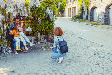 Beautiful family with children on old paved street