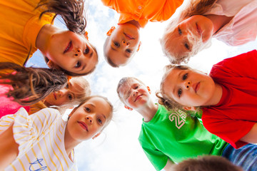 Kids standing together in circle looking at the camera