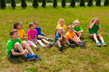 Group of children sitting together on the grass