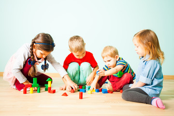 Kids playing with wooden blocks at kindergarten