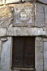 Forged, metal cross and door, stone carving. Orthodox temple Cathedral of the Resurrection of Christ, Podgorica, Montenegro