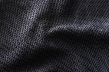 Close-up polyester fabric texture of black athletic shirt