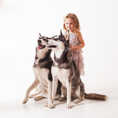 Girl and two dogs husky isolated on white