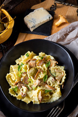 Reginette noodles in cream sauce with fresh chanterelles and capers