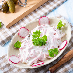 delicious homemade meat salad with mayonnaise and cucumber