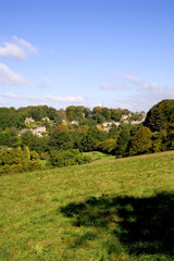 Fototapeta na wymiar England, Cotswolds, Gloucestershire, early signs of Autumn in the trees around pictureque Bisley village
