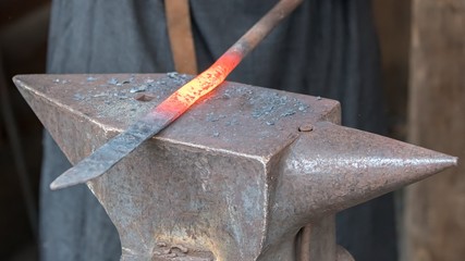 blacksmith works red hot iron