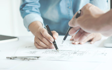 engineer architects discussing on the table with blueprint