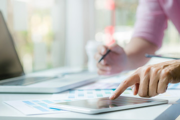 Graphic designers working on color chart at modern office