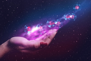 Woman hand holding cell dividing. Nebula dust. Mixed media.