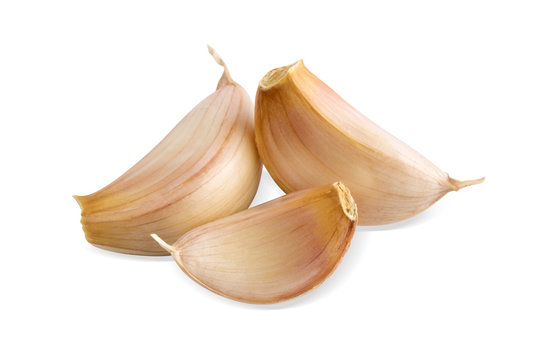 beautiful garlic unpeeled segment isolated on white background, close-up.