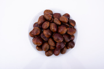 Chestnuts top view photo, chestnuts are in white plate