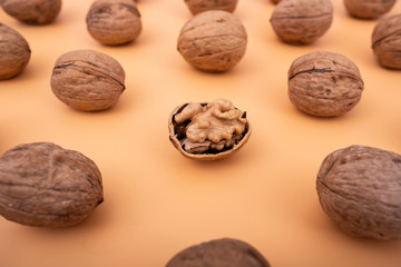 Raw walnuts on yellow solid background