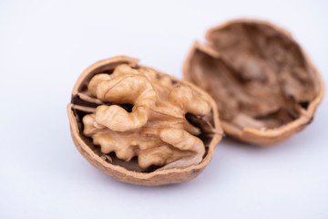 Cracked half walnut with nutshell close up macro photo