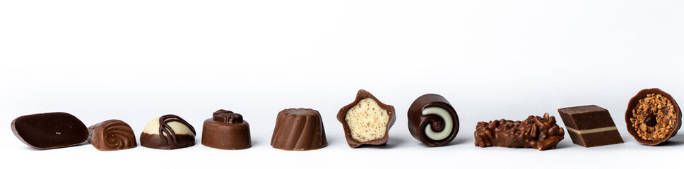 sweet chocolates in a line on a white background