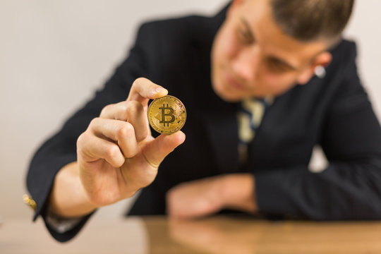 Young Businessman Trader Holding Bitcoin Cryptocurrency.