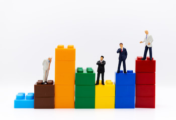 Miniature people: Businessman stand front of dashboard, display graphs, profit margins of  background. Image use for business concept.