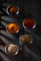 Indian Powder Spices in Glass Bowls - Vertical Image