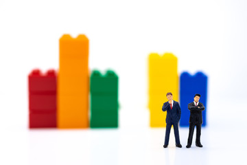 Miniature people: Businessman stand front of dashboard, display graphs, profit margins of ...