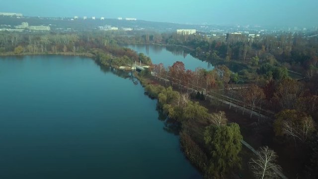 Aerial footage over Echo Park Lake, Kishinev, Moldova republic of. View of lake and smille bridge.