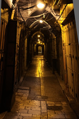 Fototapeta na wymiar Vaults of the cave street. Dark nightly narrow streets of the old city,