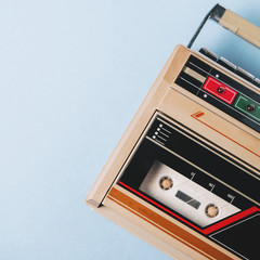 Old cassette tape recorder on a blue background