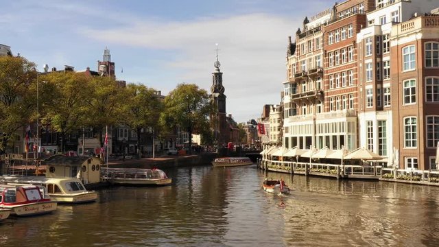 Amsterdam, Noord-Holland / The Netherlands. August 3, 2018: One of the most beautiful buildings of Amsterdam: The L&rsquo;Europe Amsterdam Hotel, with boats passing by on the Amstel