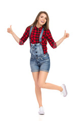 Obraz premium Smiling Casual Woman Is Standing On One Leg And Showing Thumbs Up