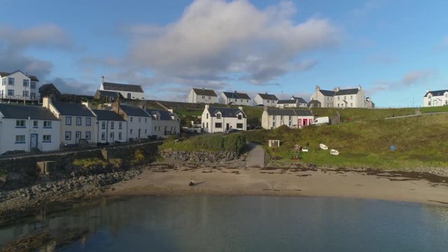 Stunning Aerial Drone Shot in Scottish Highlands, low to high reveal of Portnahaven on the Isle of Islay